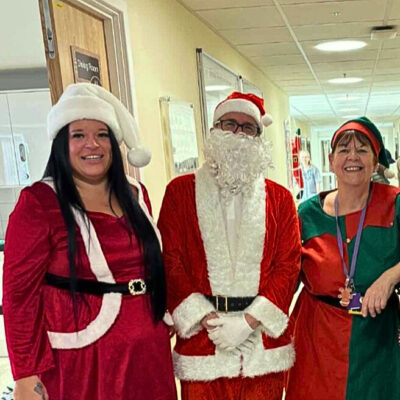 Picture of 3 members of staff Santa Claus Mrs Santa Claus and an Elf