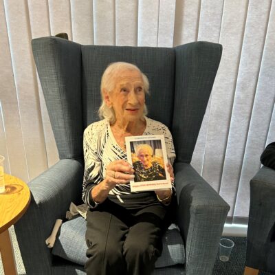 Photo of Doris holding a birthday card