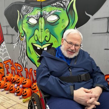 Picture of resident with green witch painted background