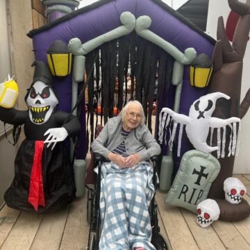 Picture of resident outside the inflatable house with funny ghosts