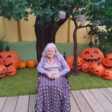 Picture of resident on decking with pumpkins
