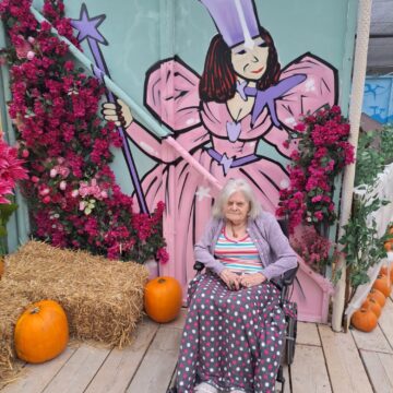 Picture of resident with fairy and pumpkin background