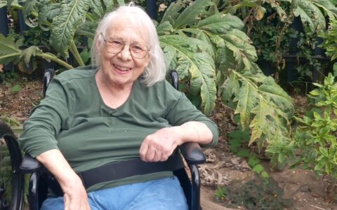 Smiling resident in wheel chair