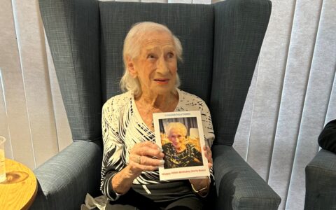 Photo of Doris holding a birthday card