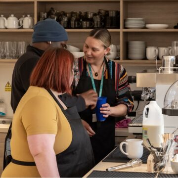 Cafe with Service Users from Project 49 serving coffee