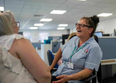 Two colleagues laughing in the office