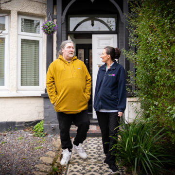 Picture of community carer leaving the house with service user