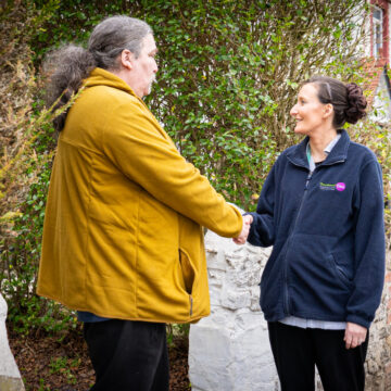 Carer and Service User shaking hands