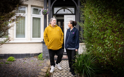 Picture of community carer leaving the house with service user