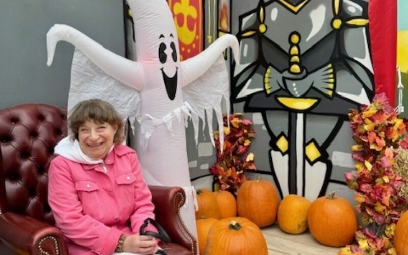 Chrissy surrounded by pumpkins