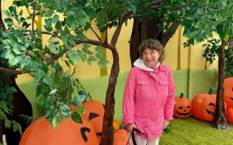 Chrissy under a tree with pumpkins