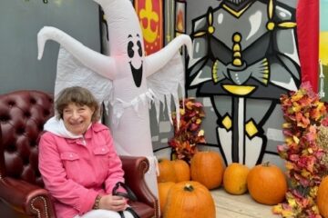 Chrissy surrounded by pumpkins
