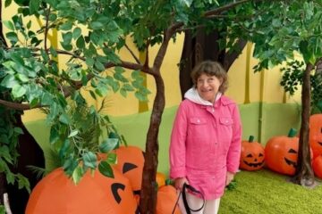 Chrissy under a tree with pumpkins